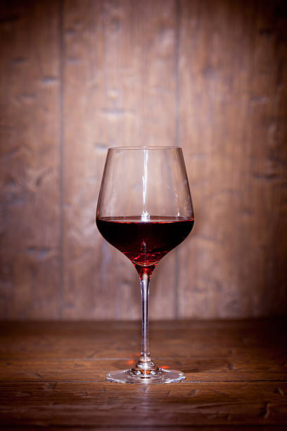 istock Wine glass on wooden background 514407594