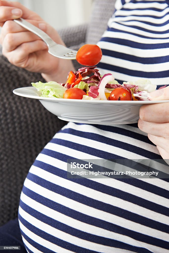 Close Up Of Pregnant Woman Eating Healthy Salad 30-39 Years Stock Photo
