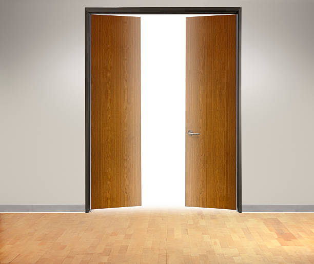 istock Pair Of Office Doors Open Into Brightly Lit Office 514408572