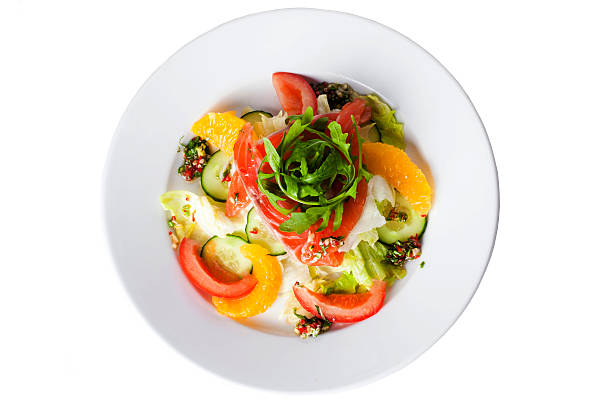 salad with red fish, tomatoes, cucumbers and oranges stock photo