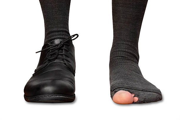 istock the legs of a man in tattered socks 514410298