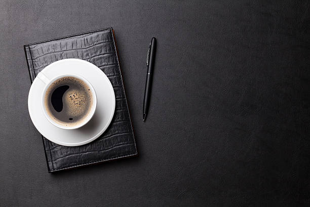 istock Office leather desk table with coffee and supplies 514411140