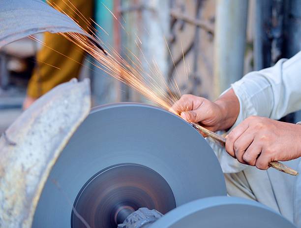 istock sharpening the blade of the knife 514411704