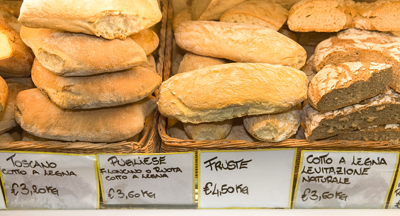 Fresh bread for sale at a traditional Italian market.  Concepts could include food, health, culture, travel, and others.