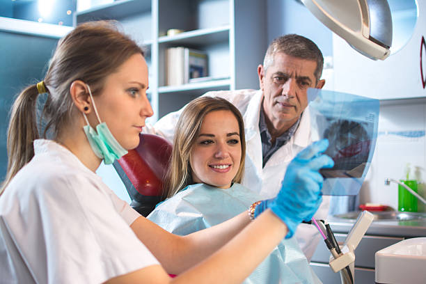 istock Female patient looking her x-ray image at dentist. 514414064