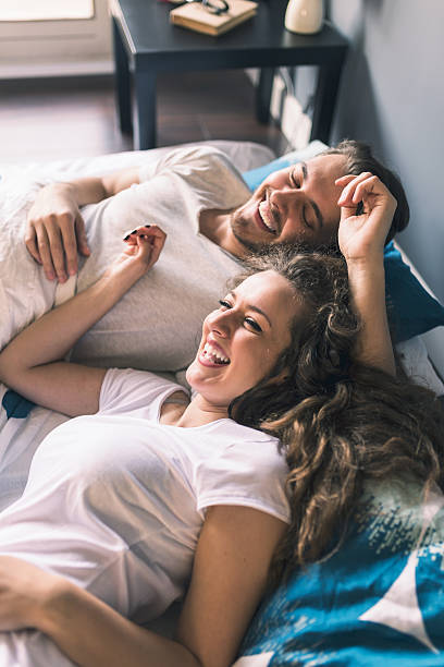 istock Young serene couple laying in bed and smiling 514414092