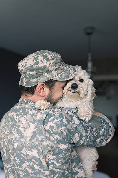 istock Finally home. Soldier hugging his dog. 514415432