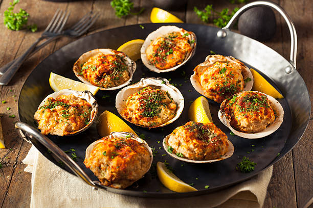 Homemade Baked Clams with Lemon Homemade Baked Clams with Lemon and Parsley stuffed stock pictures, royalty-free photos & images