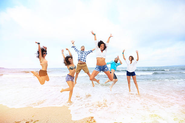 istock Happy friends jumping over the water 514416890