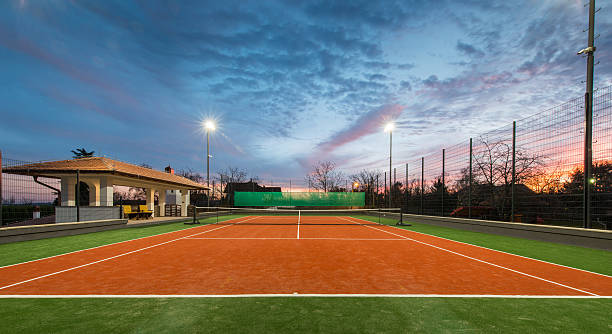 Tennis court at a private estate Tennis court at a private estate in the twilight and magic sky clay court stock pictures, royalty-free photos & images