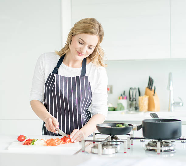 istock Woman cooking dinner at home 514419312