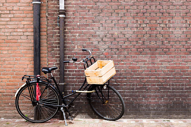 istock Retro Bicycle leaning on Brick Wall in Amsterdam 514419444