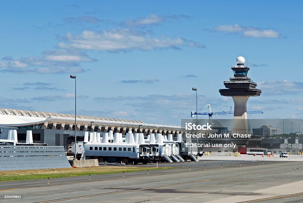 Dulles International Airport Dulles, Virginia, USA - September 14, 2013: View of the main terminal and original control tower at Dulles International Airport near Washington, D.C, with parked mobile passenger lounges lined up. Dulles International Airport Stock Photo