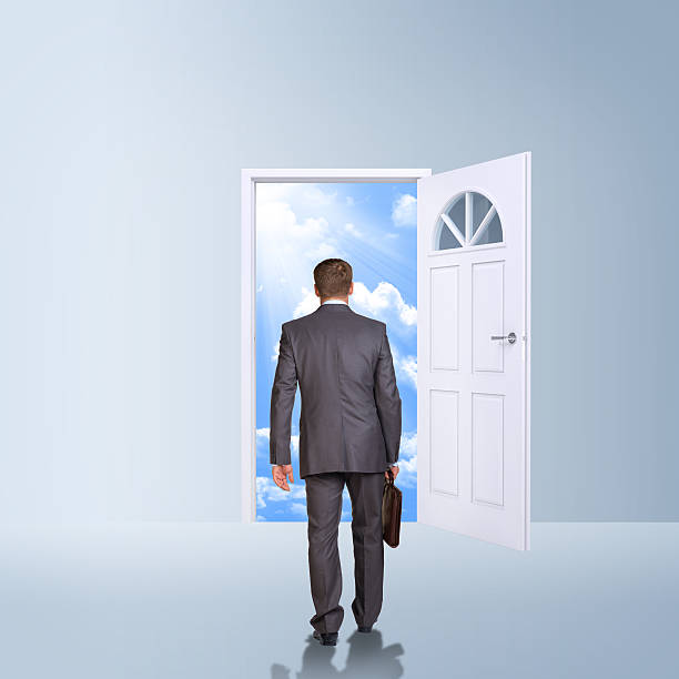 istock Businessman in suit with briefcase stepping through door 514420045