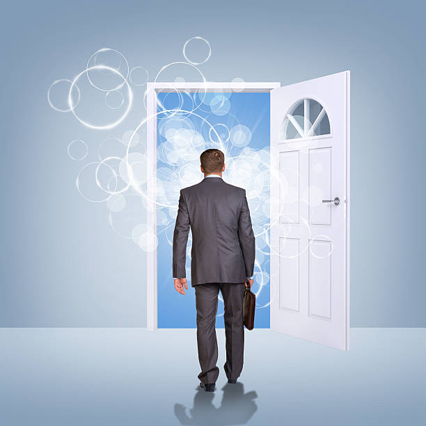 istock Businessman in suit with briefcase stepping through door 514420055
