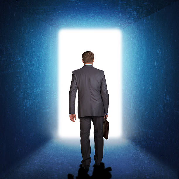 istock Businessman in suit with briefcase stepping through door 514420057