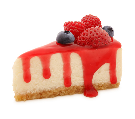 Cheesecake slice with berries and coulis isolated on white (excluding the shadow)