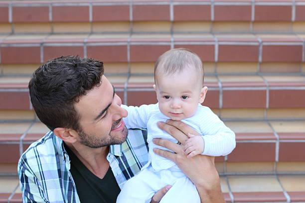 istock Young father playing with his little baby 514422778