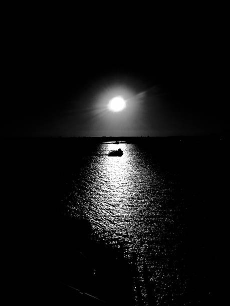 istock Boat drifting on black water in Noir style 514423838