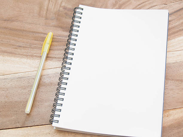 istock white note with yellw pen on wood table 514424352
