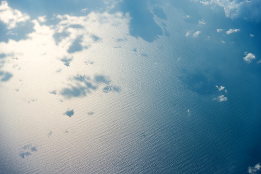Aerial view of seascape with clouds over it
