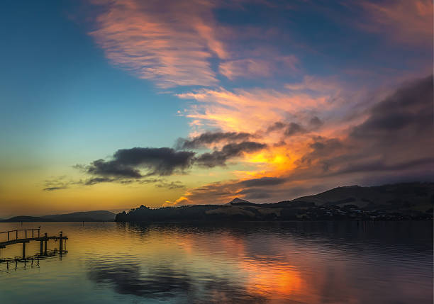 istock Orangey Red Sunrise With Clouds Over Otago Peninsula 514426288