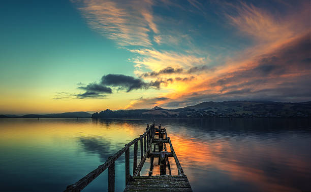 istock Pier In Otago Harbour On Cloudy Morning Displaying Colourful Sunrise 514426560