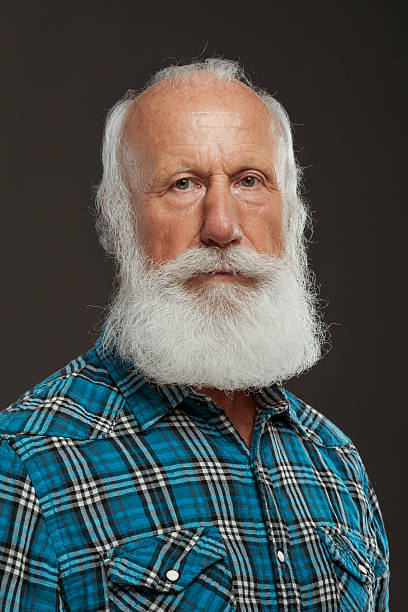 istock old man with a long beard with big smile 514437977