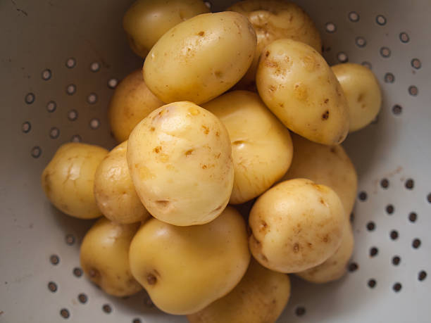 istock close up of washed  new potatoes in a collander 514439003