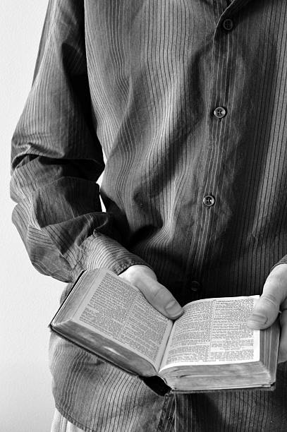 istock Man Holding Open Bible, Black and White 514441257