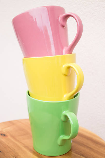 istock Sweet color mug cups on wooden table 514441925