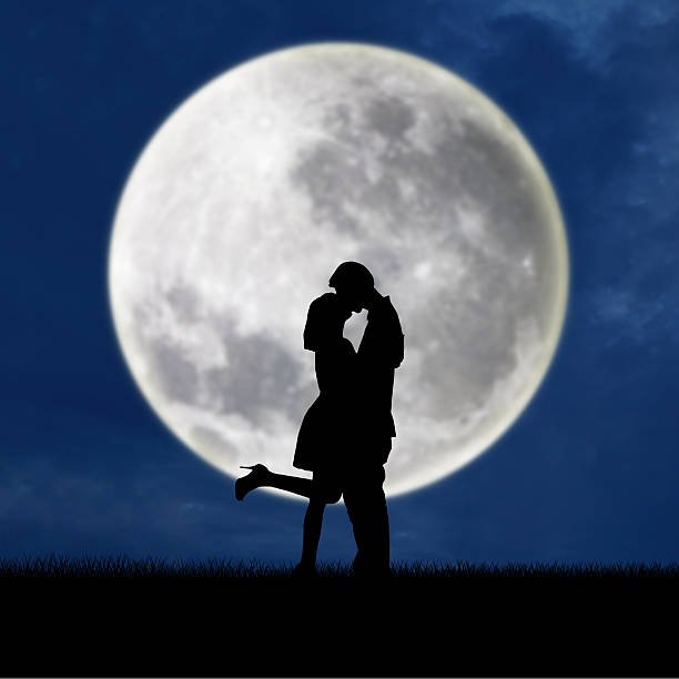 istock Couple in love on blue full moon silhouette 514443345