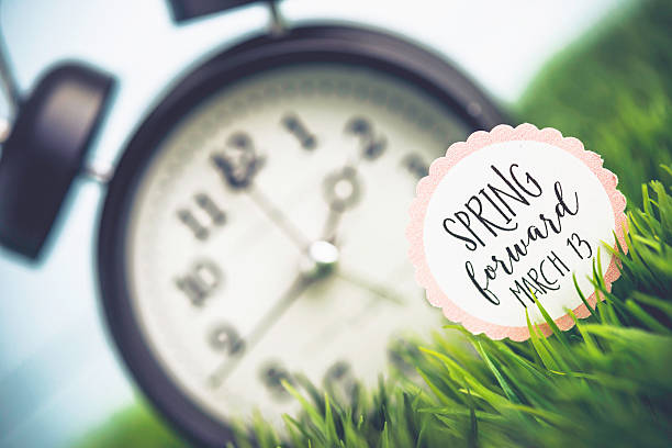 istock Clock in grass with reminder for Daylight Savings Time 514454638