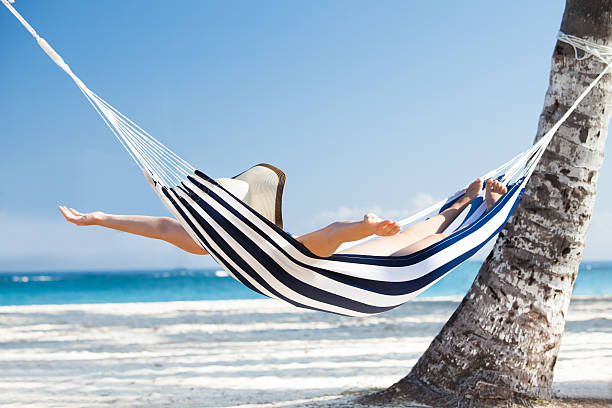istock Woman Stretching In Hammock At Beach 514454765