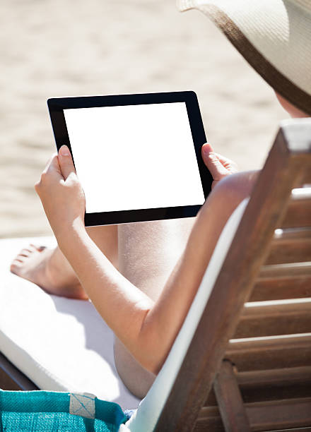 istock Woman Using Digital Tablet On Beach Chair 514454791
