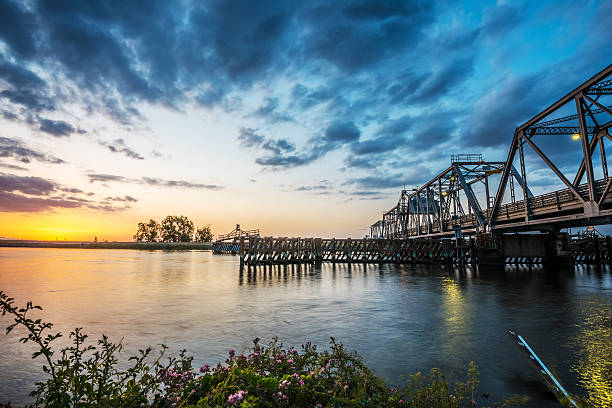 Middle River Bridge In The California Delta The Middle River Bridge at sunset over the delta. Near Discovery Bay, California. USA. Nikon D810 contra costa county stock pictures, royalty-free photos & images