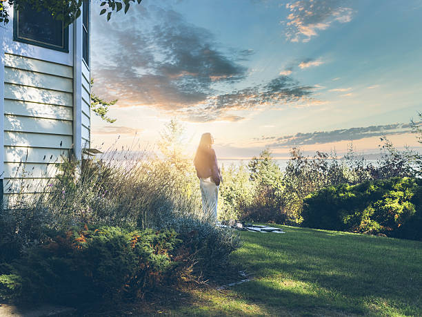 young asian woman watching sunrise, standing at the yard, San Juan Island, WA, USA.
