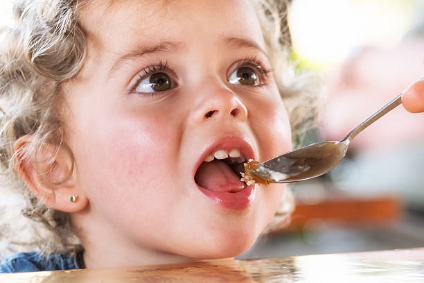 istock Little girl eating 514458593