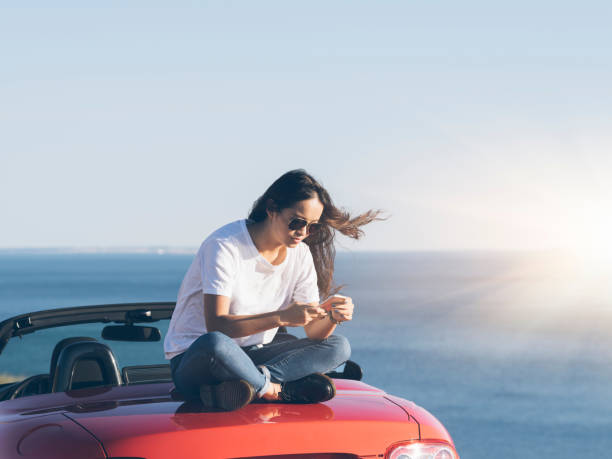 istock asian woman  using cellphone  on the cabriolet 514459334