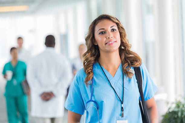 istock Happy hospital nurse walking in hallway during shift 514459589