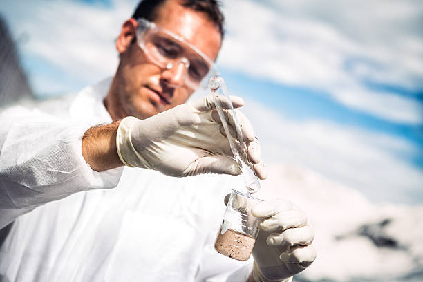 Examing Water Scientist examing toxic water. chemical worker stock pictures, royalty-free photos & images
