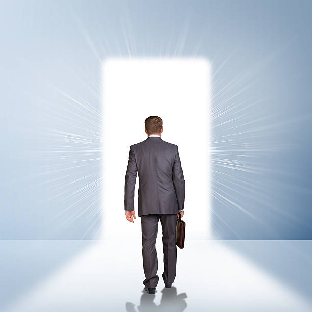 istock Businessman in suit with briefcase stepping through door 514460831