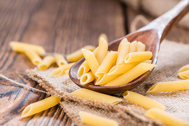 istock Raw Penne on wooden background 514461037