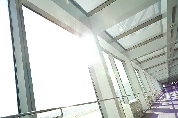 istock Sunny on modern glass office windows building interior corridor 514461651
