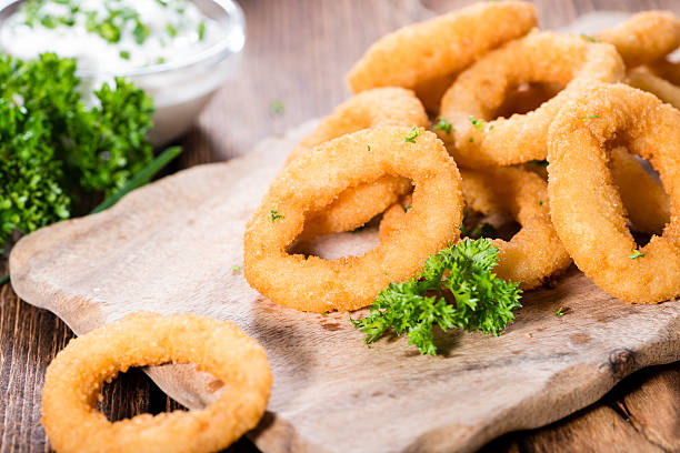 istock Onion Rings on wooden background 514461803