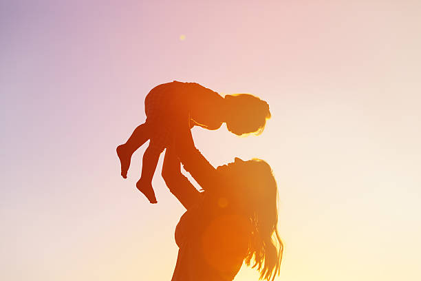 istock mother and little daughter play at sunset 514465970