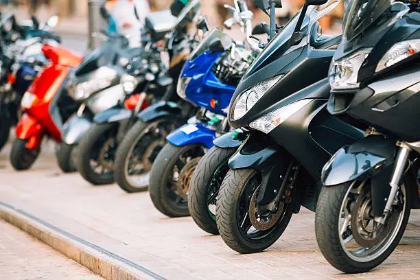 Photo of Motorbike, motorcycle scooters parked in row in city street
