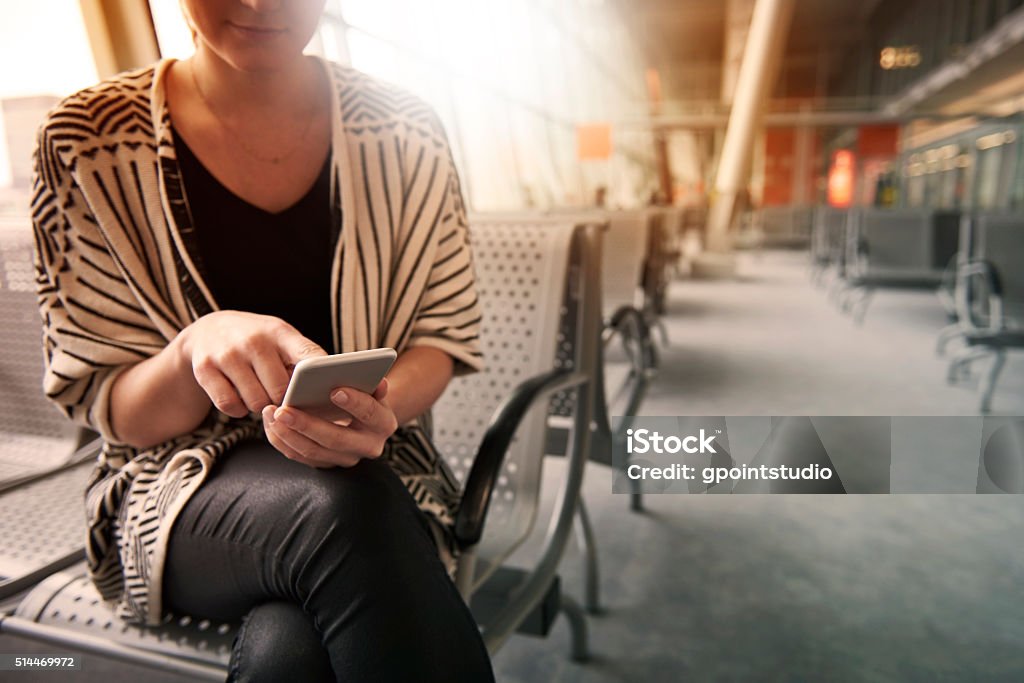 Surfing the net before the flight Mobile Phone Stock Photo