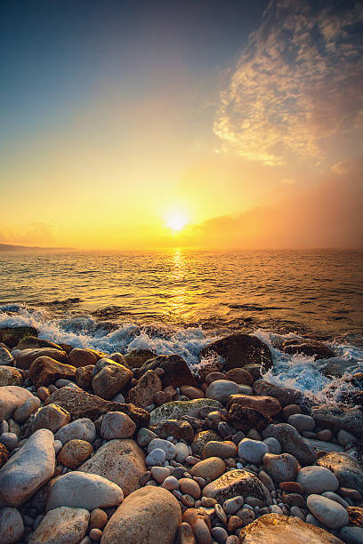 istock Tropical colorful sunrise at the stones beach. 514472360
