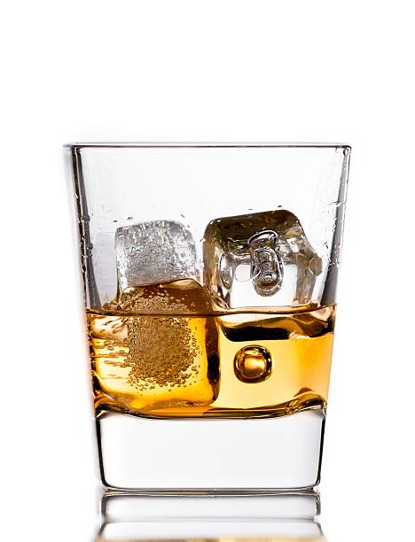 istock scotch whiskey in glass with ice cubes on white 514472552